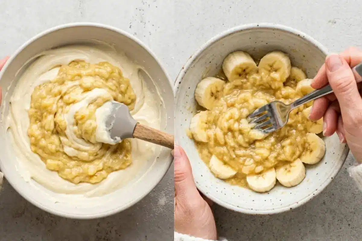Why This Banana Cheesecake Works A split image captured from an overhead angle on a light-grey textured concrete surface showing the process of making banana cheesecake; on the right, a hand mashes fresh banana slices in a speckled ceramic bowl with a fork, and on the left, a spatula folds the mashed fruit into the creamy batter.