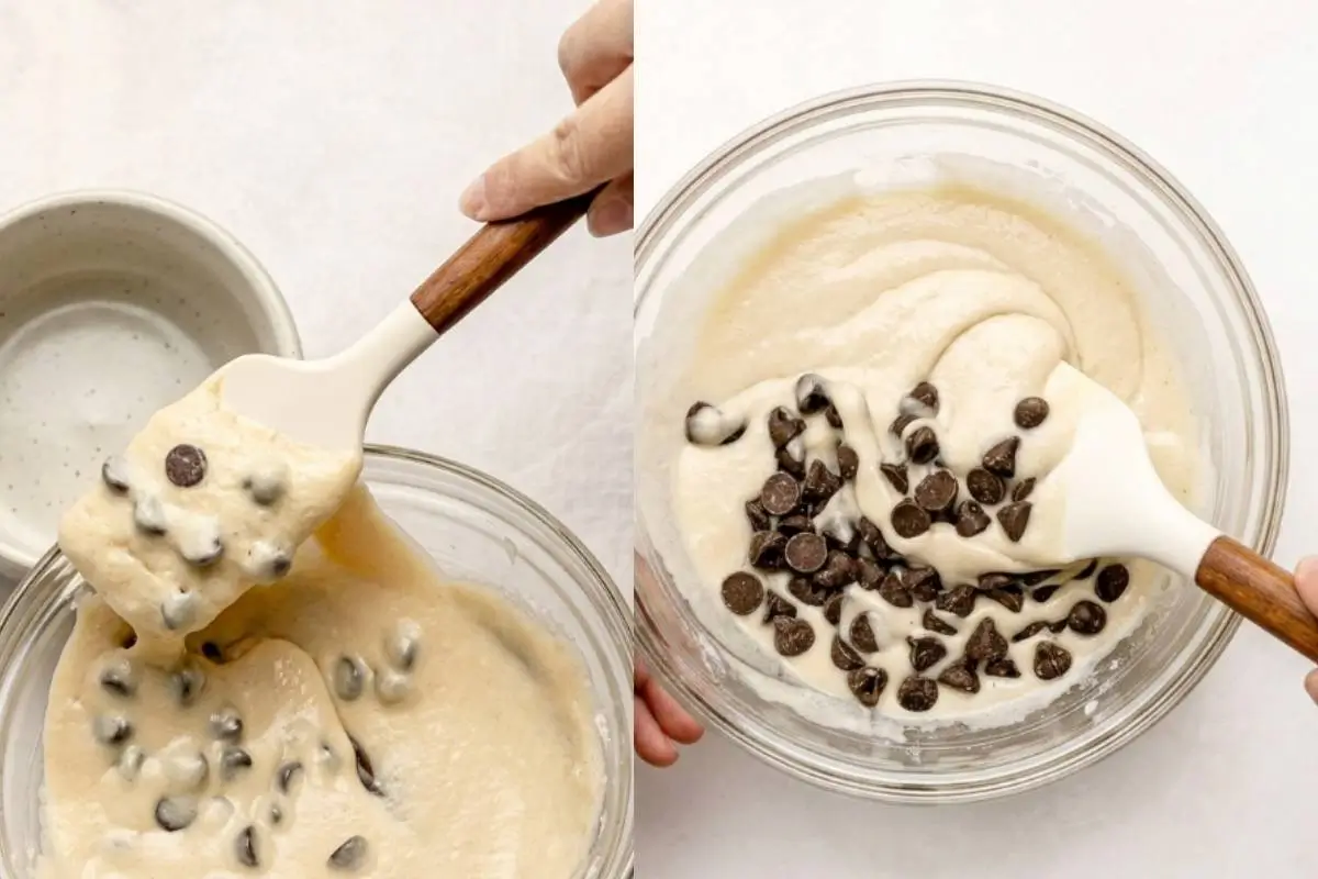 A side-by-side demonstration showing the final steps of making a chocolate chip mug cake, featuring dark chocolate chips resting on top of a smooth, creamy batter in a glass bowl on the right, and a hand using a rustic wooden-handled spatula to gently fold the chips into the dough on the left.